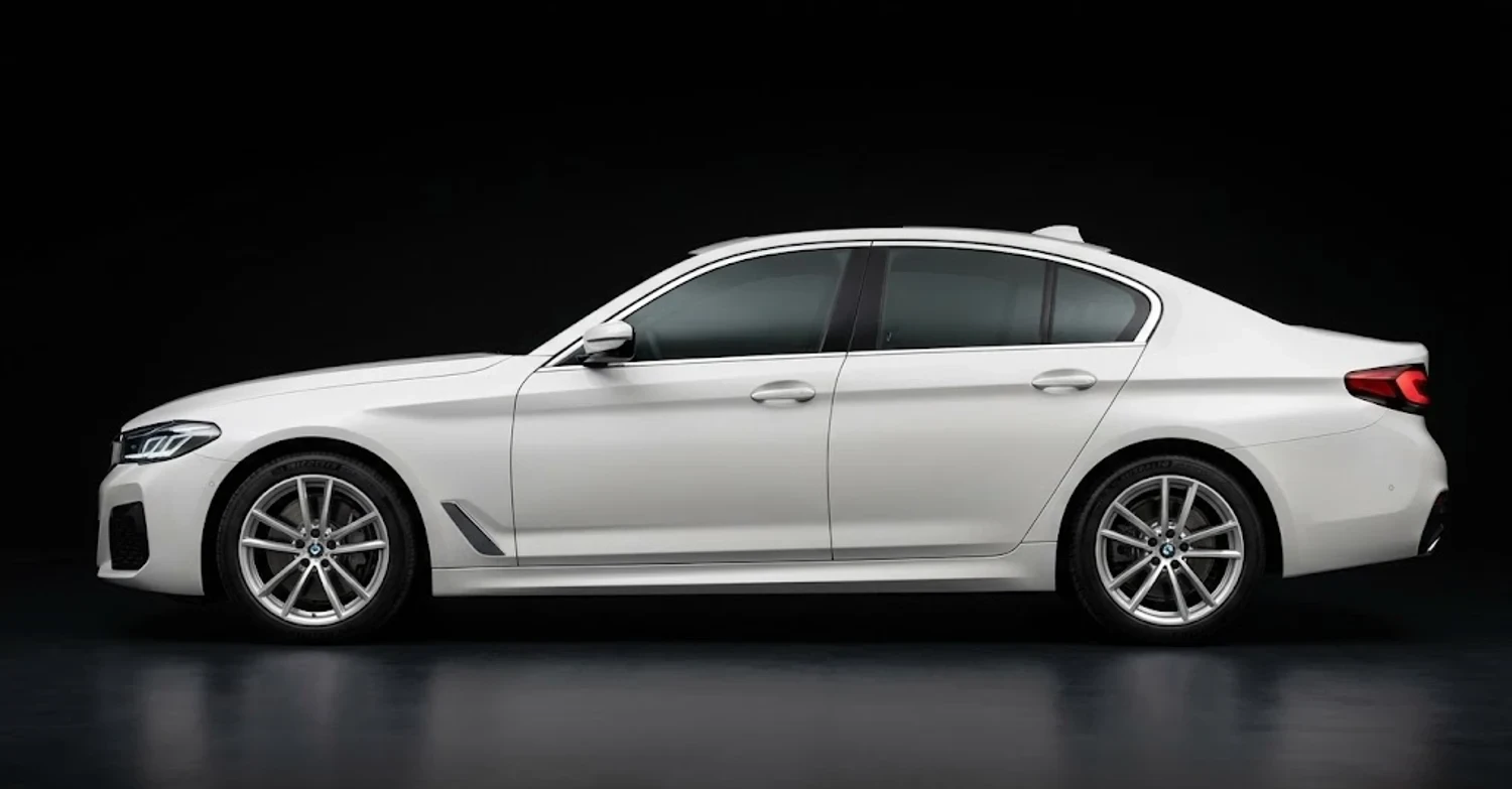 A white BMW 5 Series seen from the side