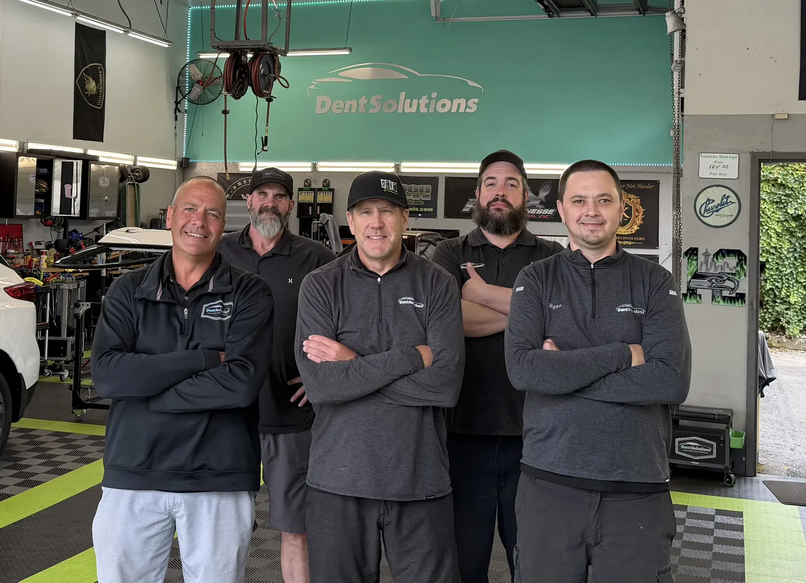 The Dent Solutions NW team in the Bellevue shop, owner Doug Hillius with the crew