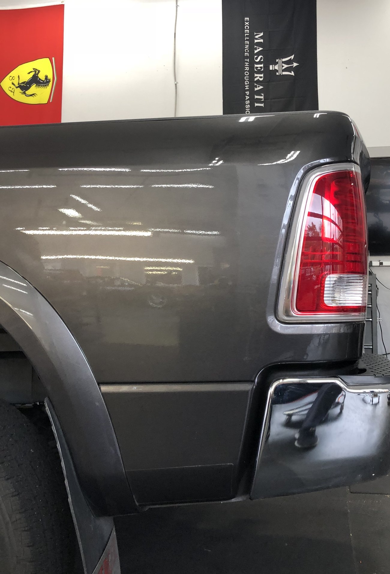 The same Dodge Ram bedside after paintless dent repair, the reflection running straight and the factory paint untouched