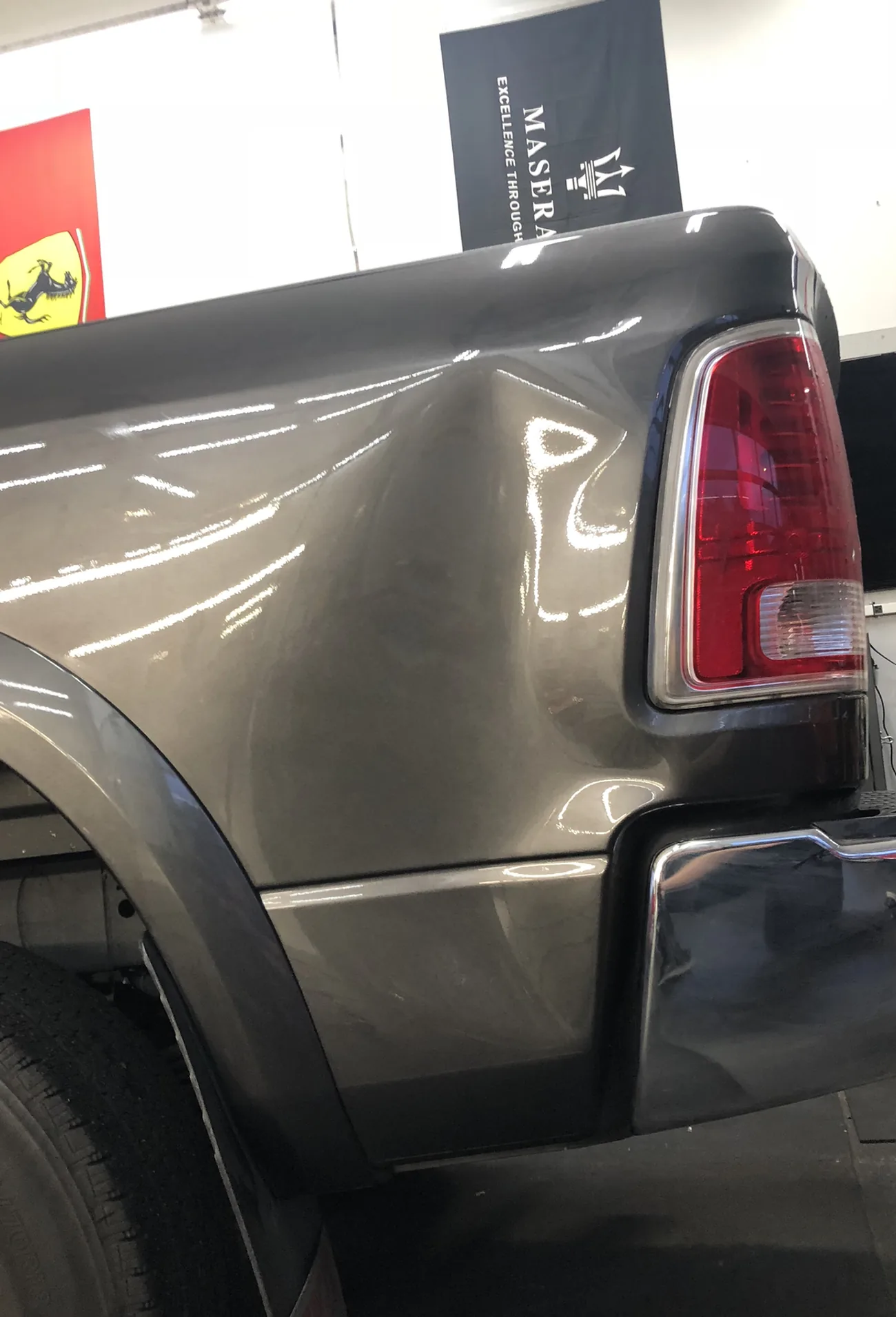 A dent in the bedside of a Dodge Ram before paintless dent repair