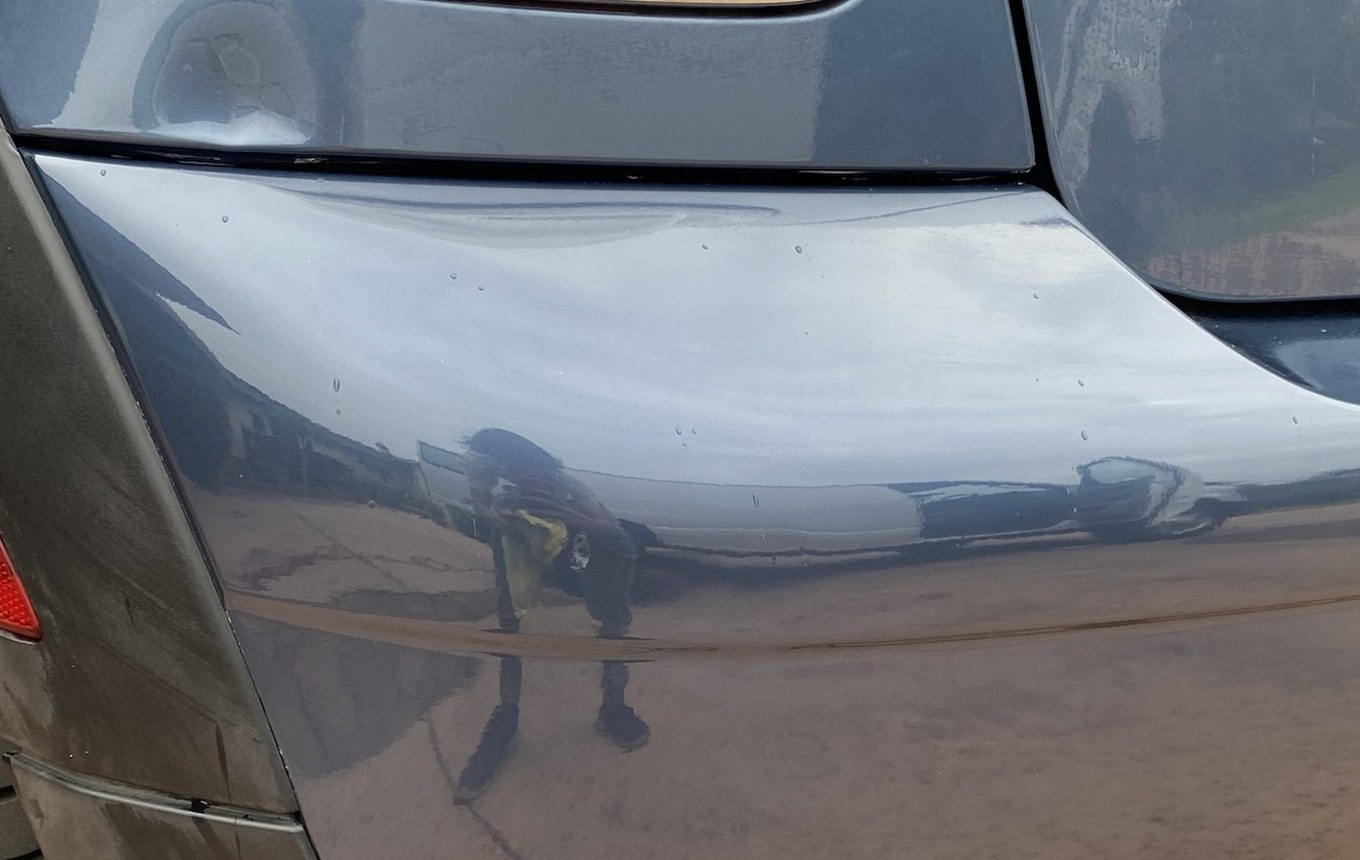 The same MINI Cooper rear bumper corner after the dent was reshaped