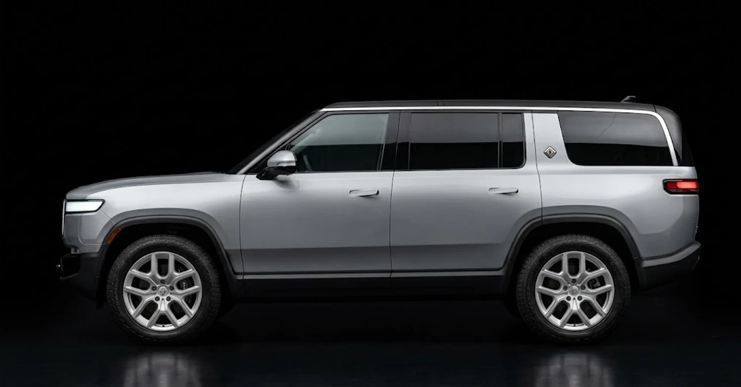 A Rivian R1S photographed side on with its paint untouched