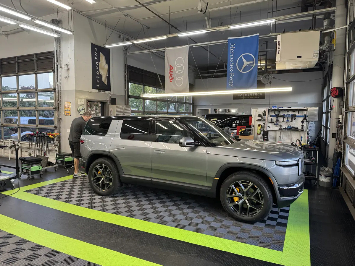 The Dent Solutions NW shop floor in Bellevue, with the Audi and Mercedes-Benz banners on the wall