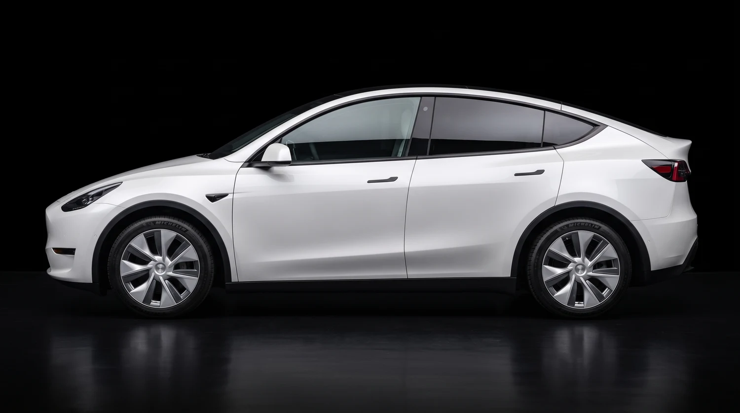 A Tesla Model Y photographed side on with its paint untouched