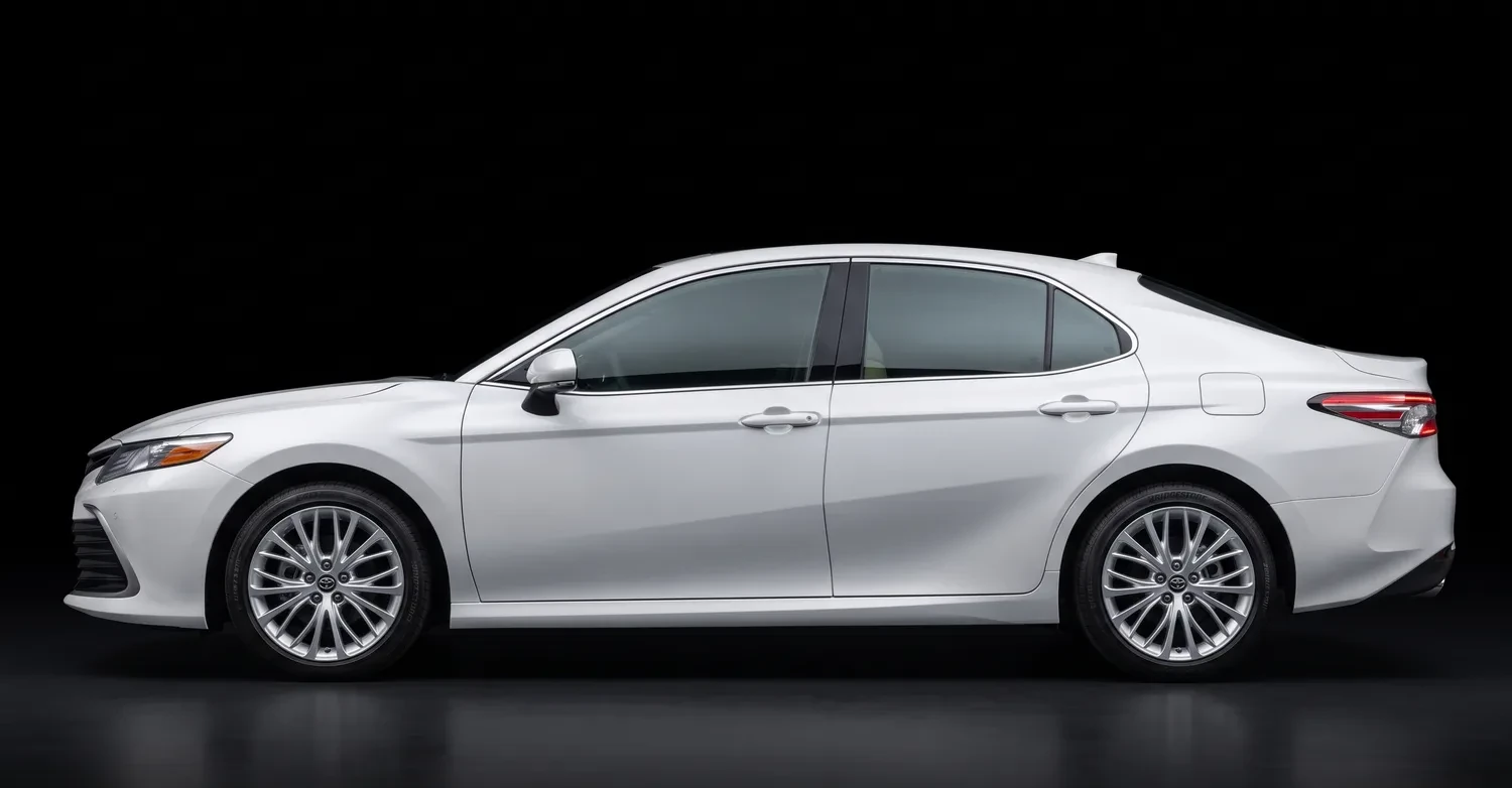 A white Toyota Camry seen from the side